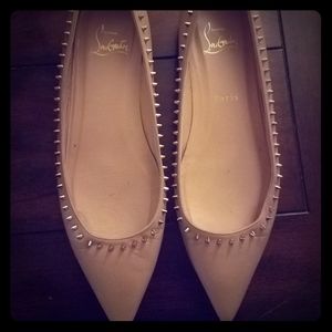 Christian Louboutin beige spiked flats.